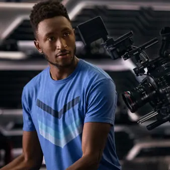 Marques looking into a large camera. 